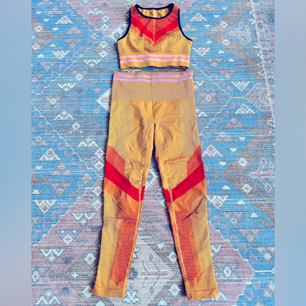 LNDR tan, orange, red, and pink leggings and matching sports bra. Size S